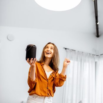 woman-controlling-light-with-a-smart-speaker-at-home.jpg